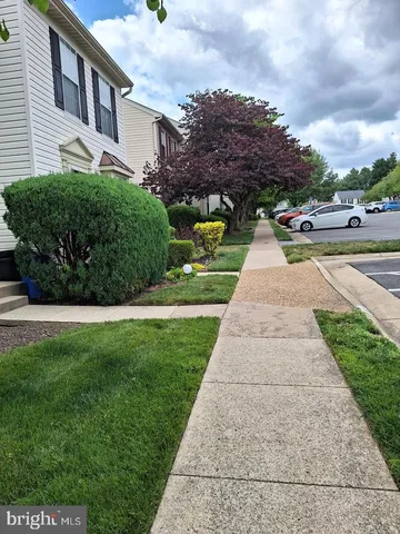 a living room with a table chairs and a kitchen view