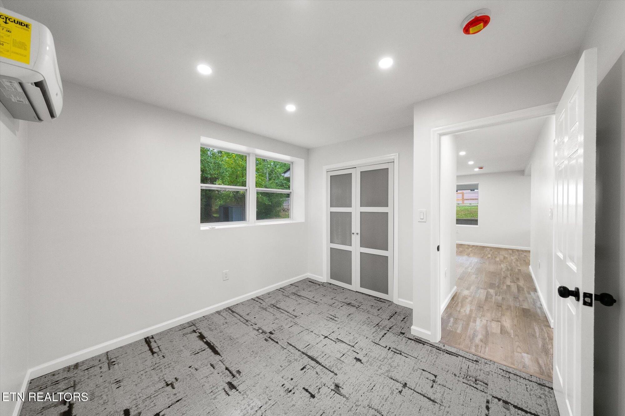 103 Parsons Road Oak Ridge, TN 37830 - Photo 12 of 27 a view of a bedroom with wooden floor and windows