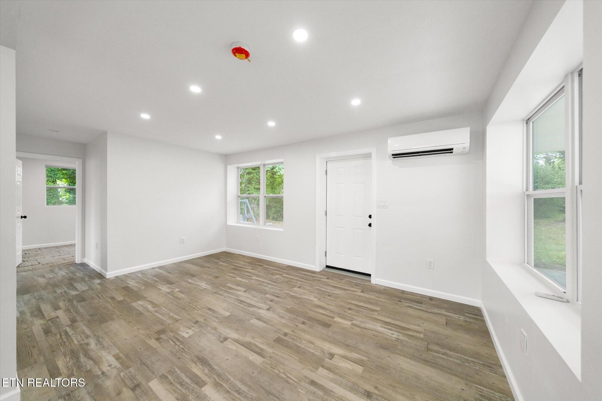 103 Parsons Road Oak Ridge, TN 37830 - Photo 4 of 27 a view of an empty room with wooden floor and a window