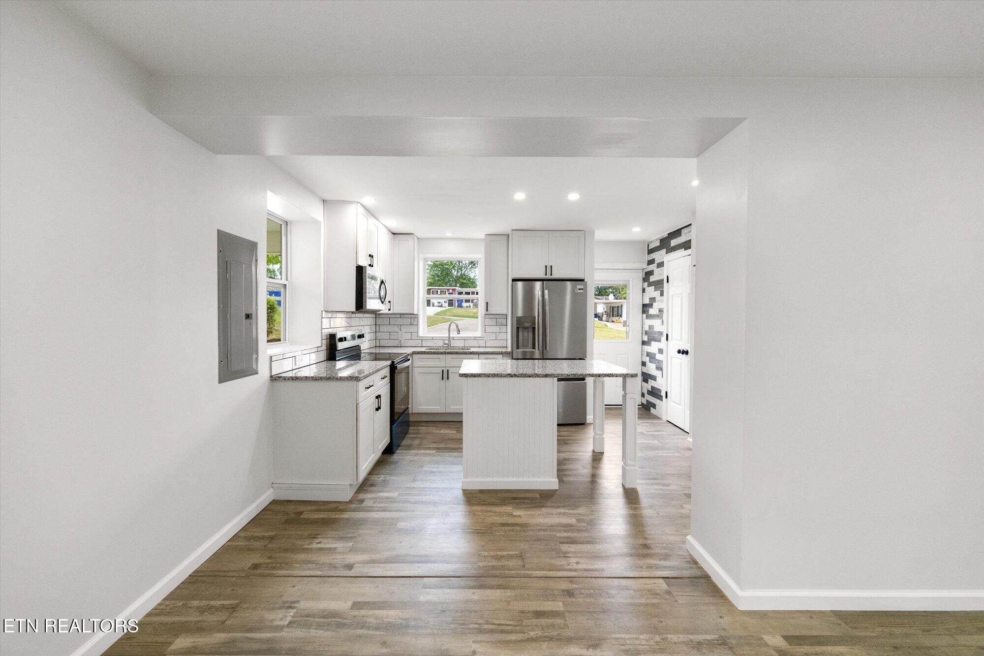 103 Parsons Road Oak Ridge, TN 37830 - Photo 8 of 27 a kitchen with white cabinets and stainless steel appliances