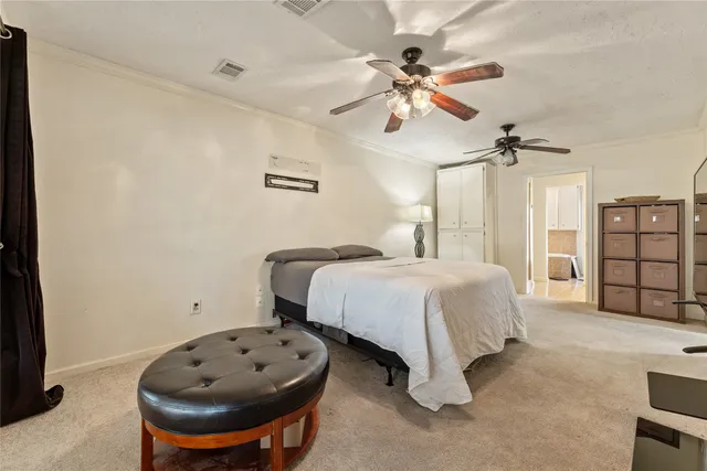 a spacious bedroom with a bed and a chandelier