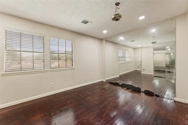 a view of a kitchen with a sink and wooden floor