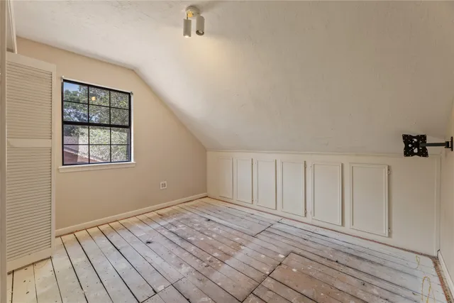 a view of a livingroom with wooden floor and window
