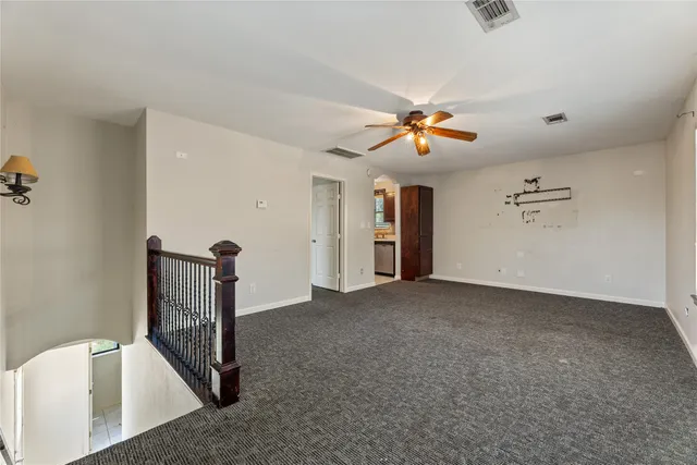 a view of empty room with ceiling fan