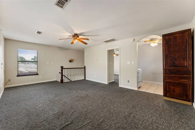 a view of an empty room with a ceiling fan