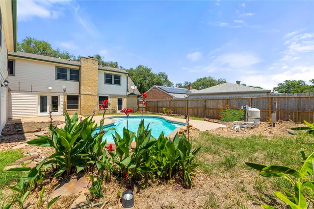 a view of a house with a yard and sitting area