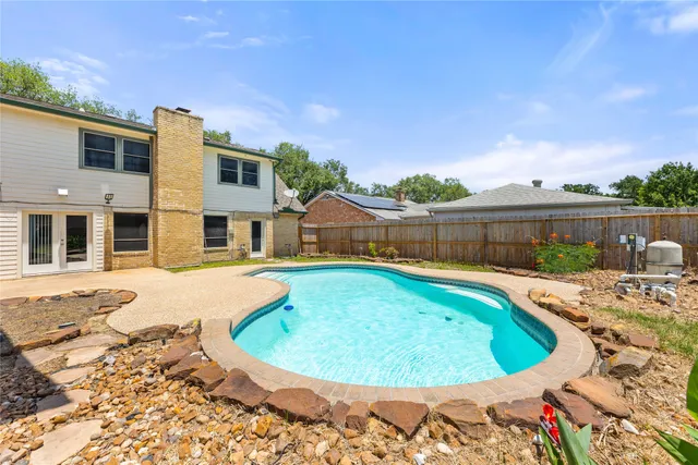 a view of a swimming pool with a lounge chairs