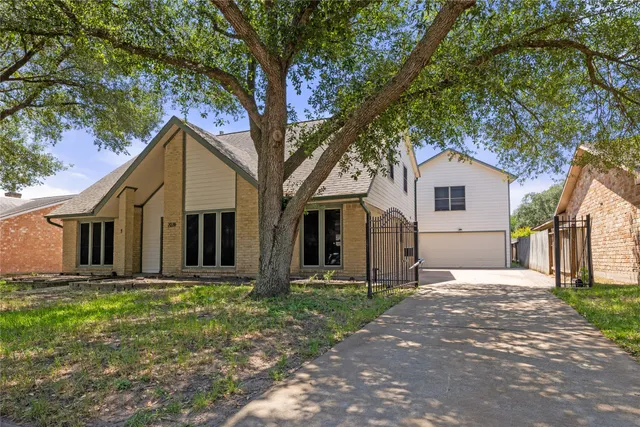 a front view of house with a garden