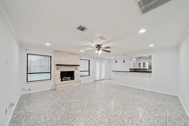 a view of a livingroom with a fireplace and window
