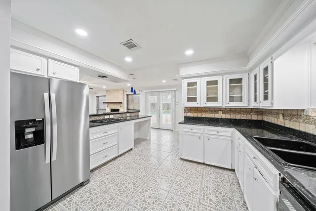 a kitchen with stainless steel appliances a refrigerator sink and stove