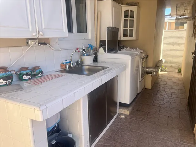 a kitchen with stainless steel appliances a sink and cabinets