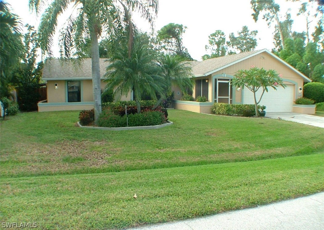 17408 Lebanon Road Fort Myers, FL 33967 - Photo 1 of 20 a view of a house with a big yard potted plants and large tree