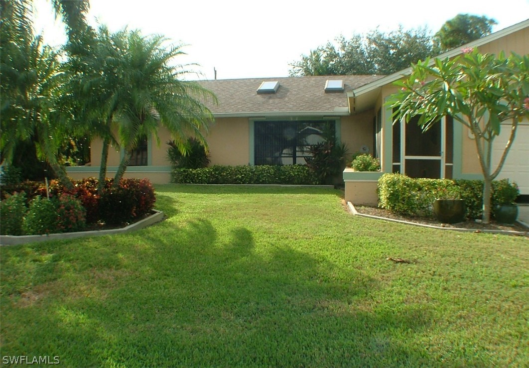 17408 Lebanon Road Fort Myers, FL 33967 - Photo 2 of 20 a front view of a house with garden and porch