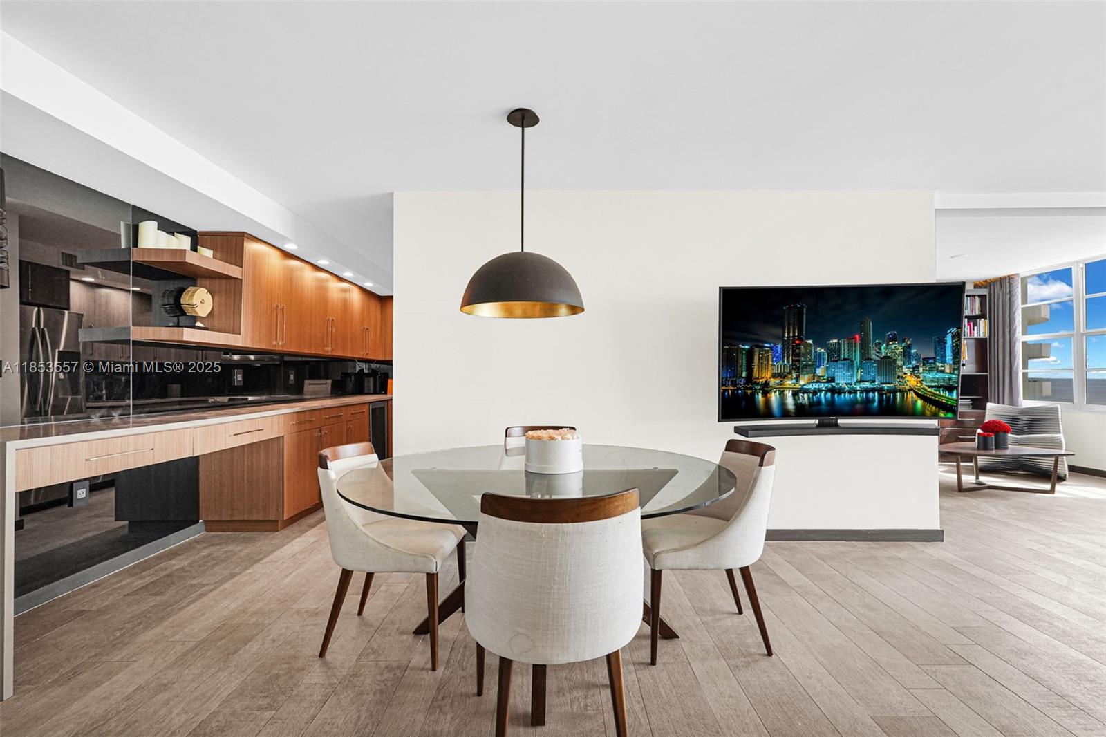 5151 Collins Avenue, Unit 1519 Miami Beach, FL 33140 - Photo 11 of 42 a kitchen with a table and chairs in it