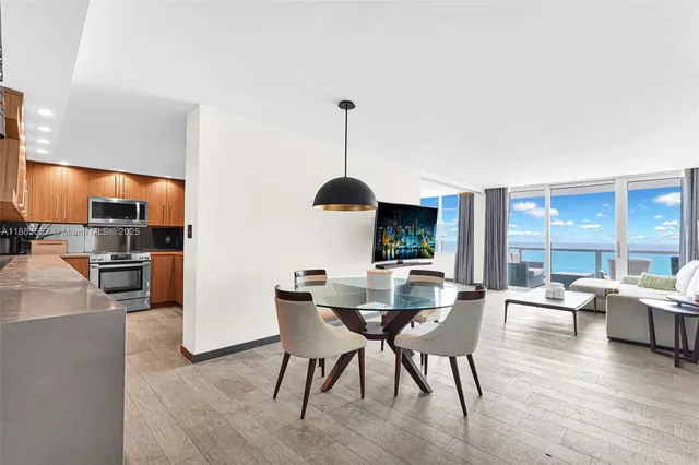 a view of a dining room with furniture window and wooden floor
