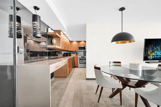 a kitchen with stainless steel appliances granite countertop a stove a sink and a refrigerator