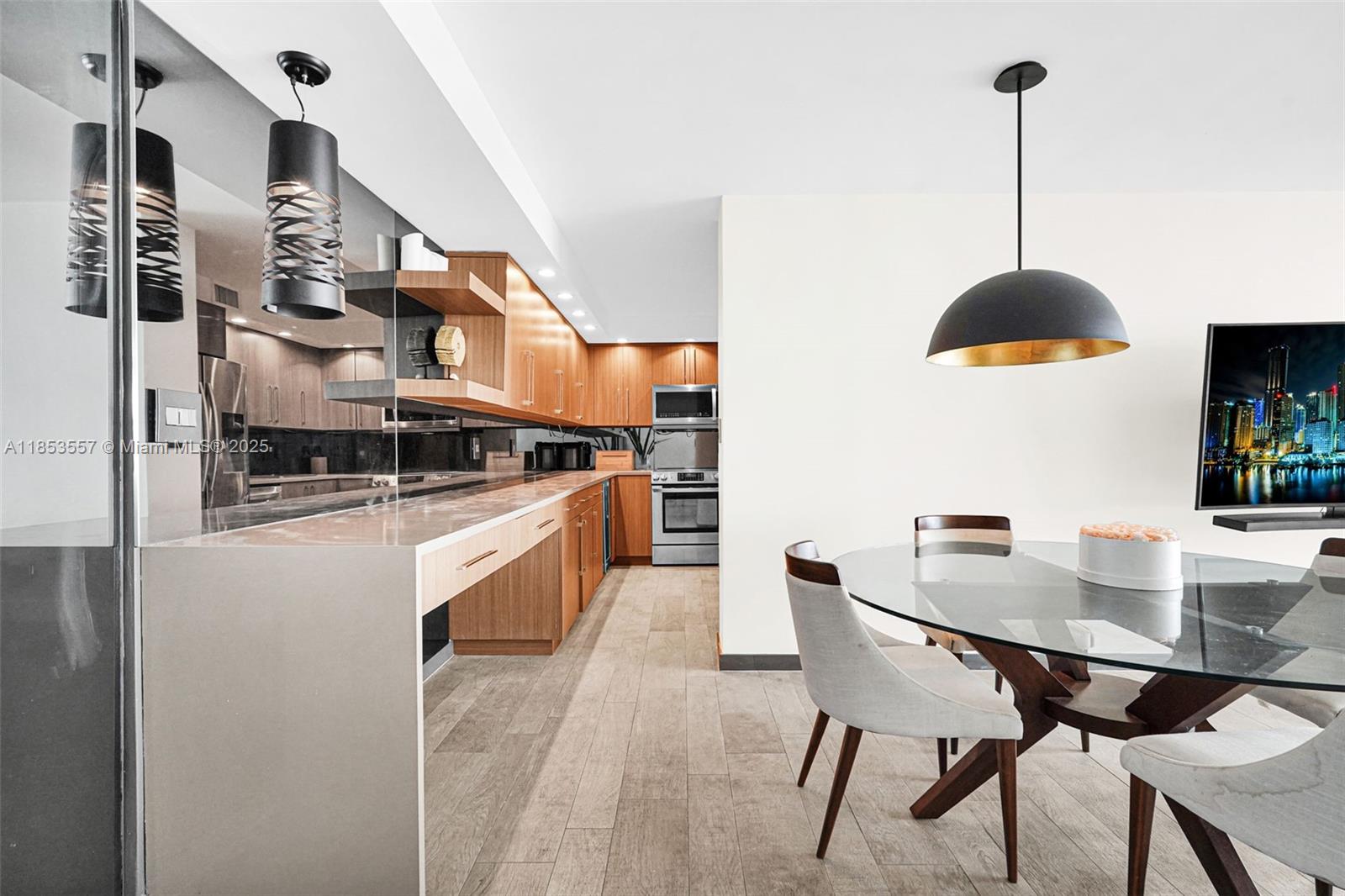 5151 Collins Avenue, Unit 1519 Miami Beach, FL 33140 - Photo 13 of 42 a kitchen with stainless steel appliances granite countertop a stove a sink and a refrigerator