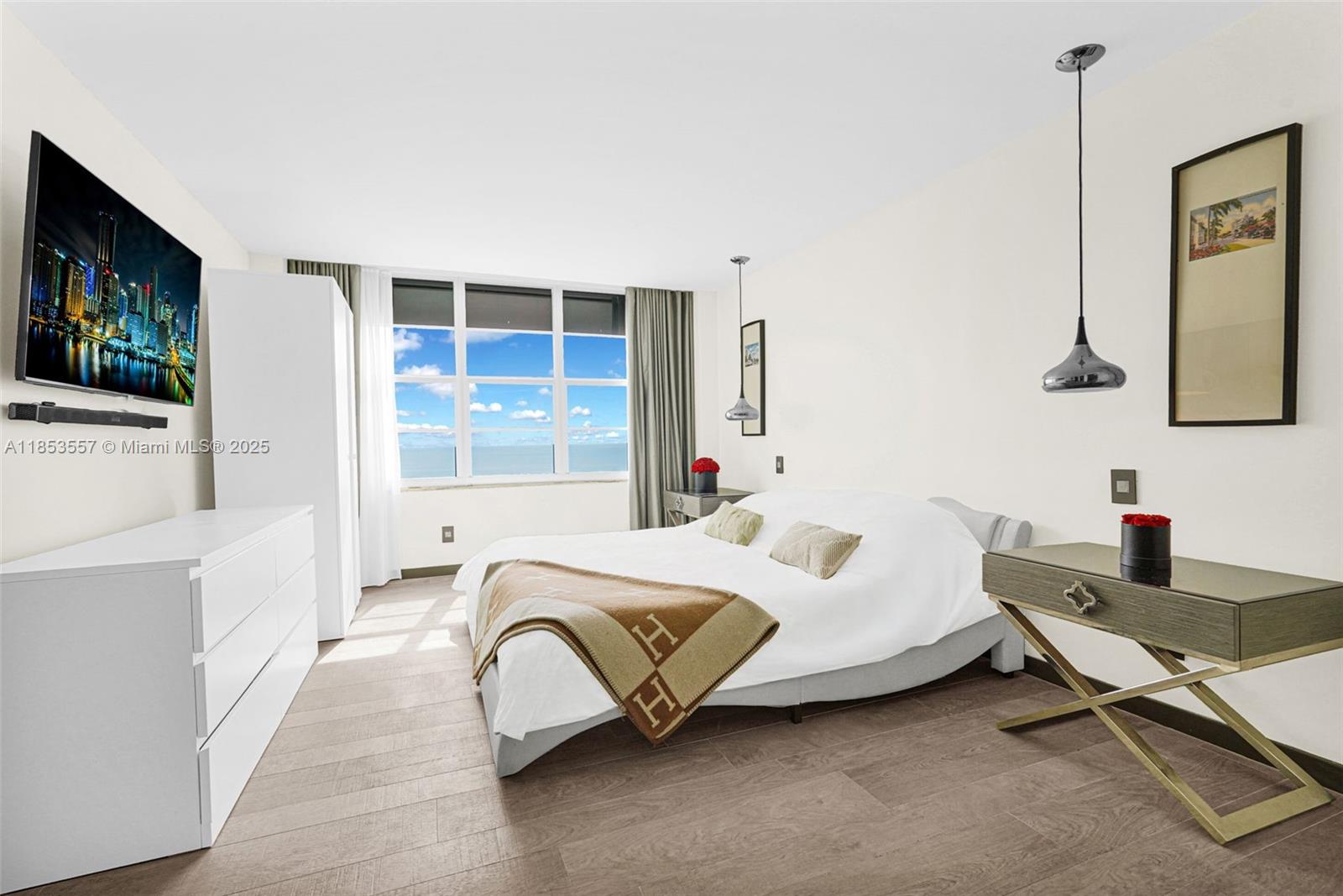 5151 Collins Avenue, Unit 1519 Miami Beach, FL 33140 - Photo 16 of 42 a bedroom with a bed and a flat screen tv