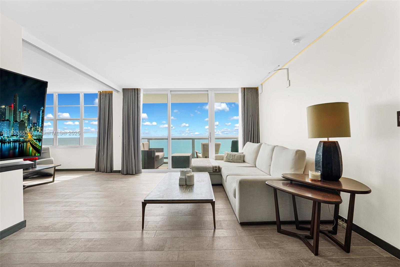 5151 Collins Avenue, Unit 1519 Miami Beach, FL 33140 - Photo 2 of 42 a living room with furniture and a table