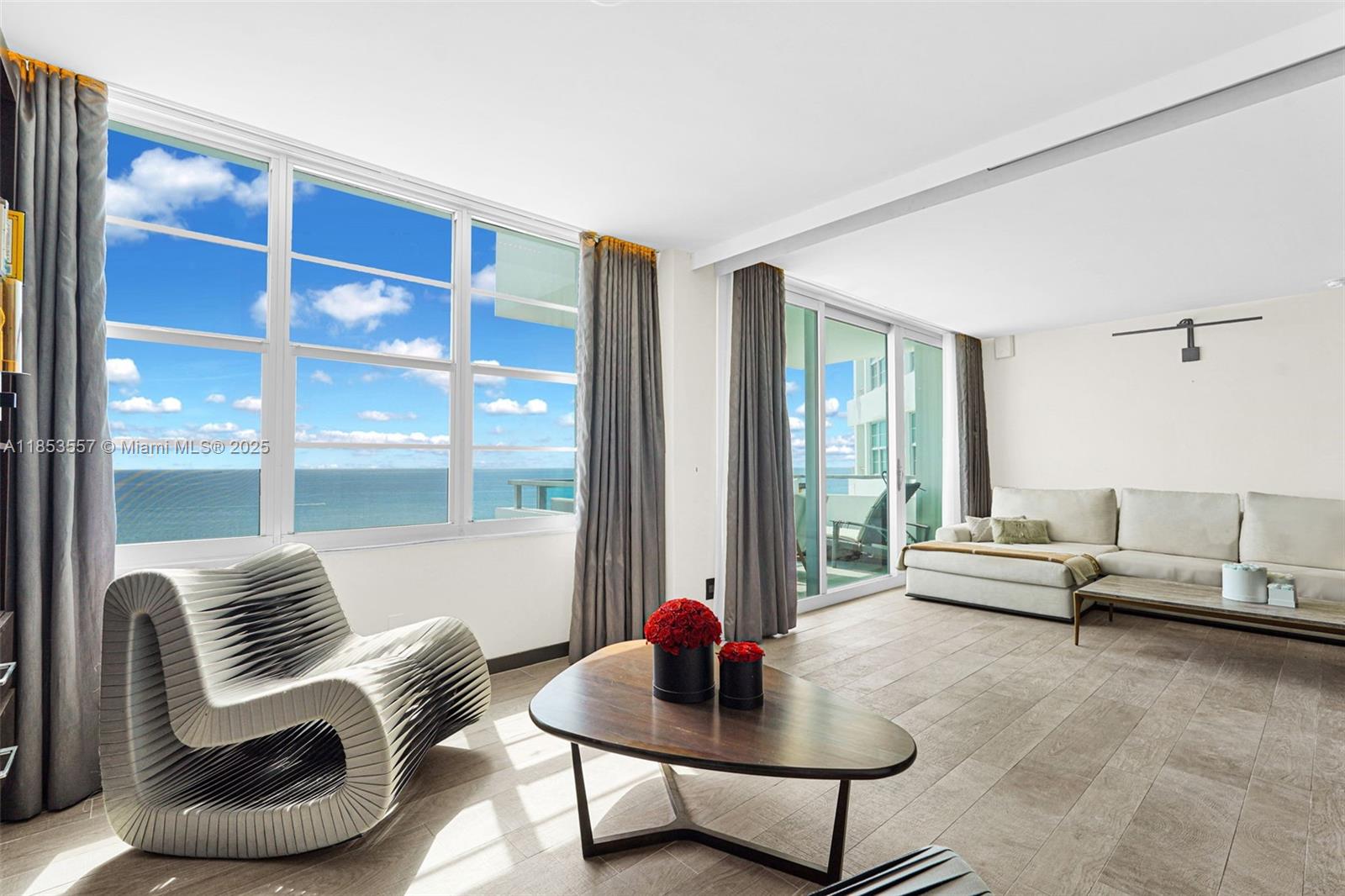 5151 Collins Avenue, Unit 1519 Miami Beach, FL 33140 - Photo 4 of 42 a living room with furniture and a large window