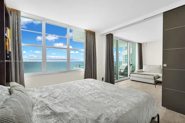 a bedroom with a bed and a large window