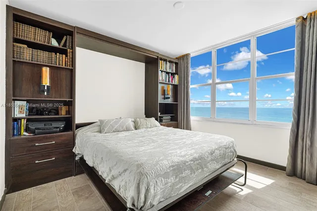 a bedroom with a large bed and a window