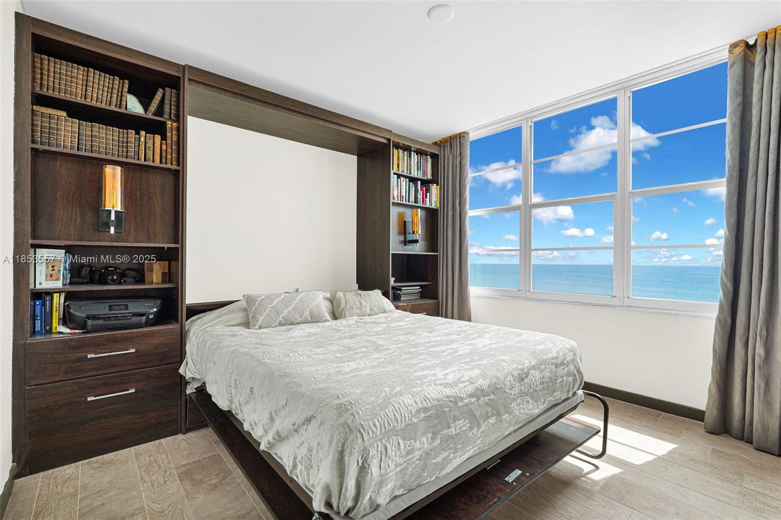 5151 Collins Avenue, Unit 1519 Miami Beach, FL 33140 - Photo 8 of 42 a bedroom with a large bed and a window