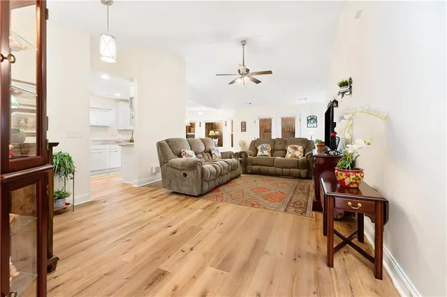 a living room with furniture and wooden floor