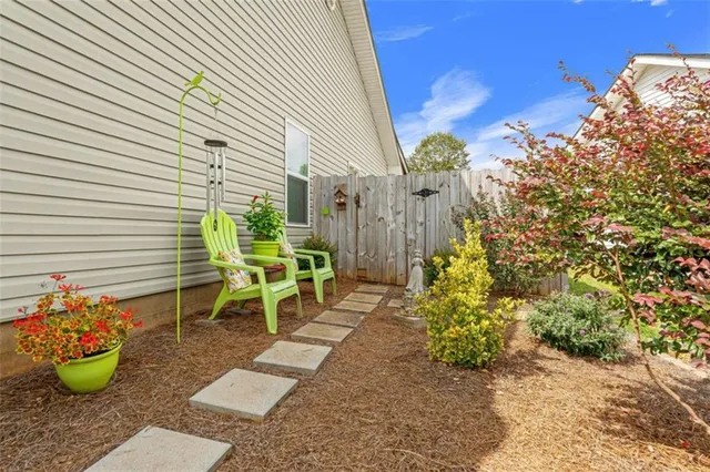 a view of a chairs and table in backyard