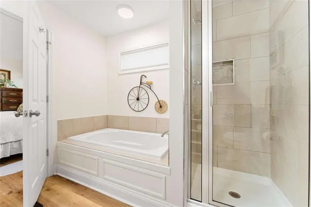 a bathroom with a tub and shower