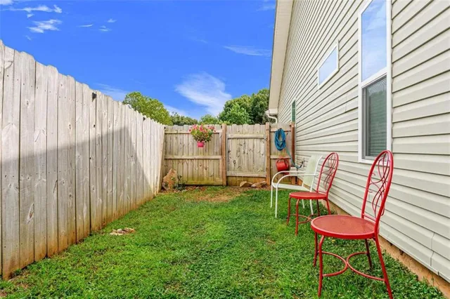 a view of a backyard with furniture and a backyard