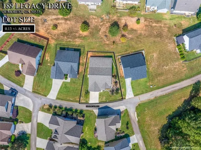 an aerial view of a residential apartment building with a yard