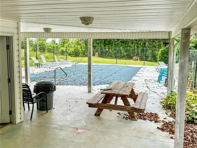 a view of a swimming pool and outdoor seating