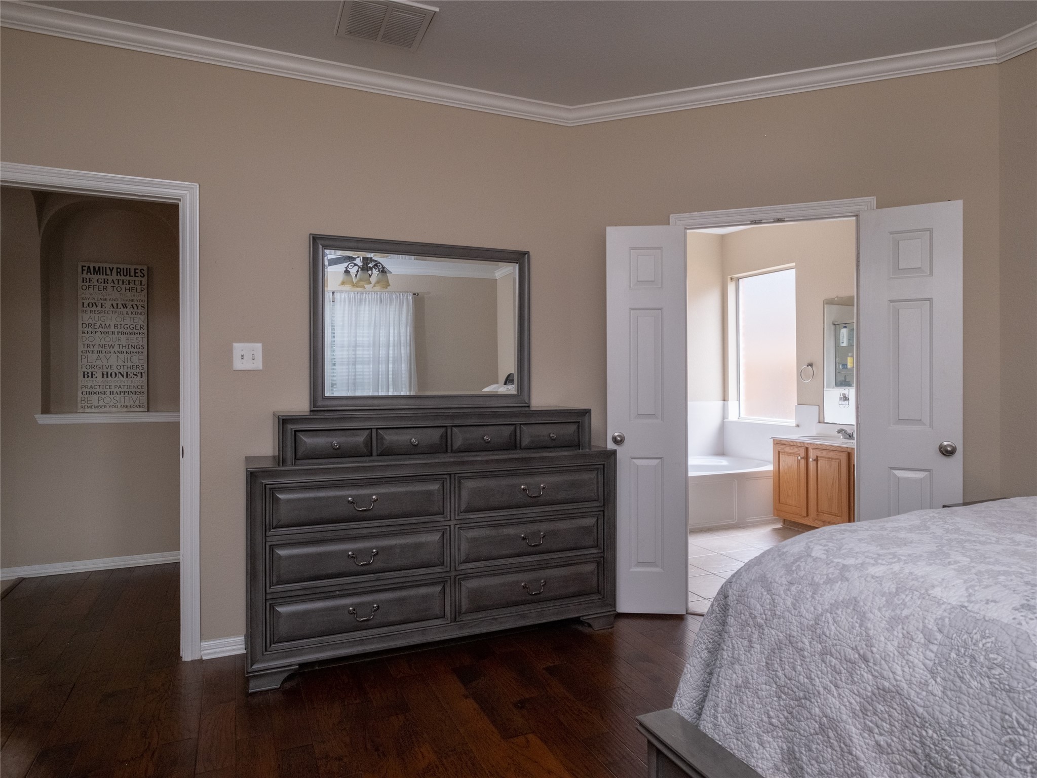 19327 Dickson Park Drive Spring, TX 77373 - Photo 23 of 47 a bedroom with a bed and a mirror on dresser