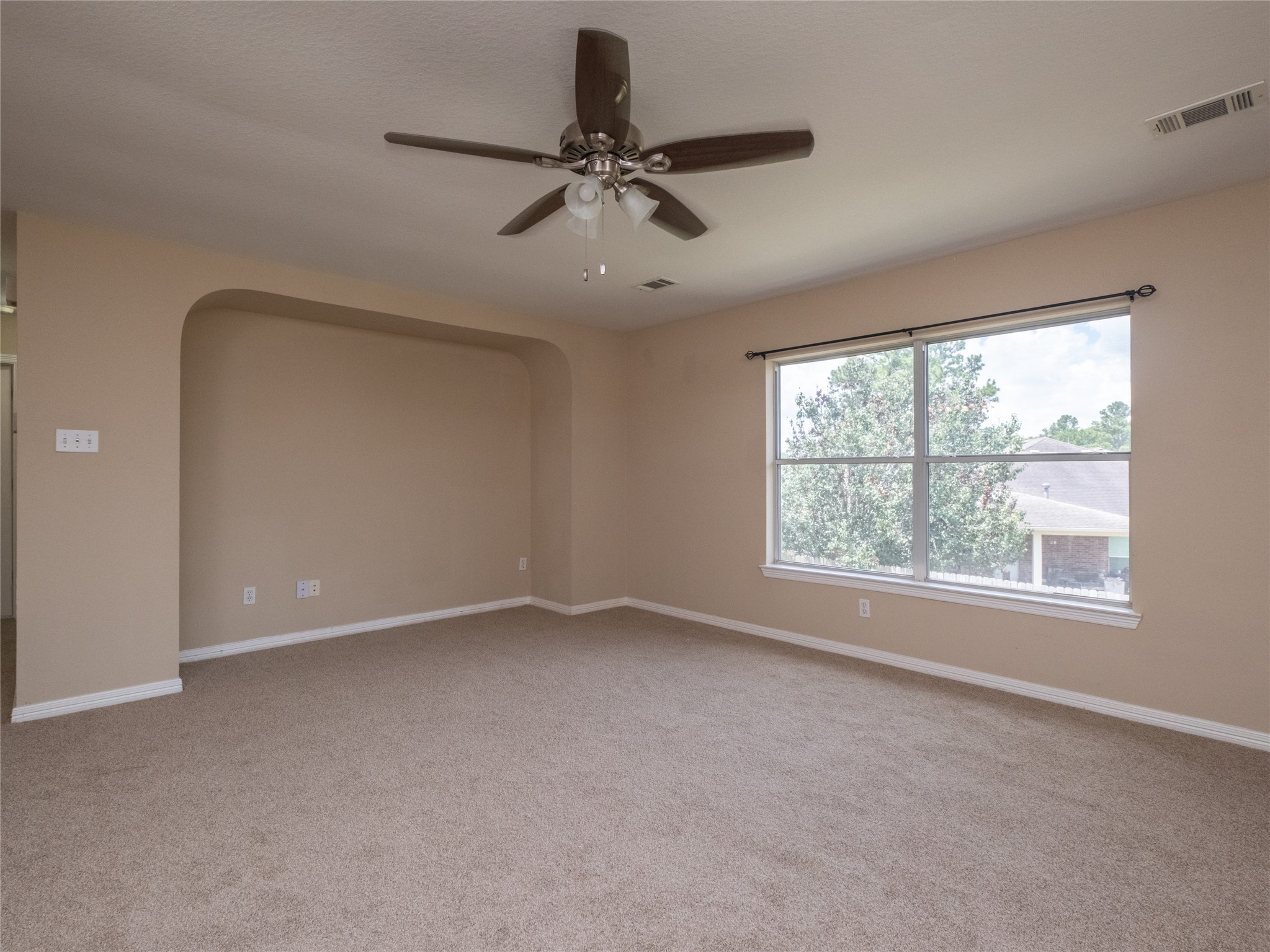 19327 Dickson Park Drive Spring, TX 77373 - Photo 29 of 47 an empty room with a ceiling fan and windows