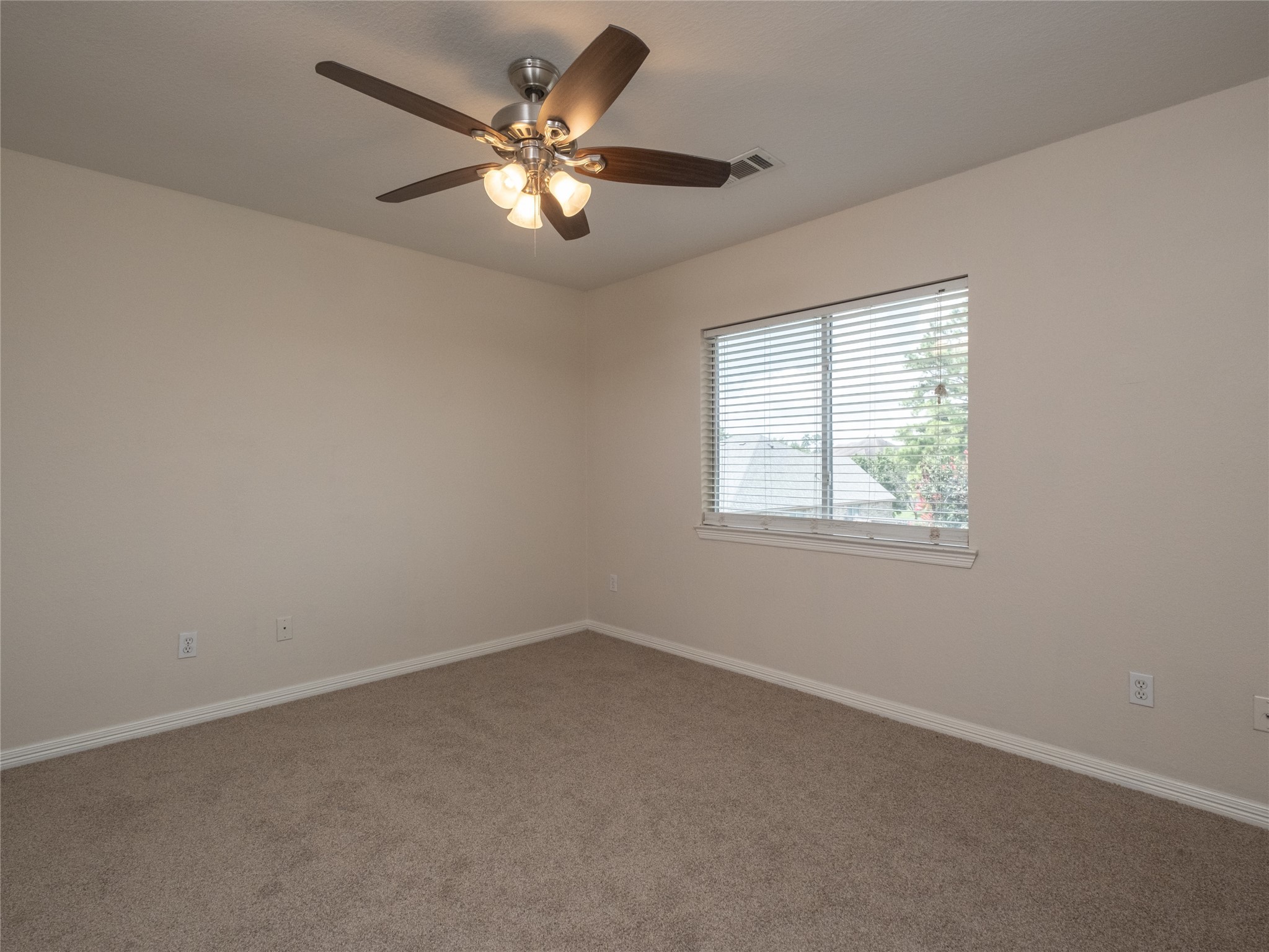 19327 Dickson Park Drive Spring, TX 77373 - Photo 35 of 47 an empty room with a chandelier fan and windows