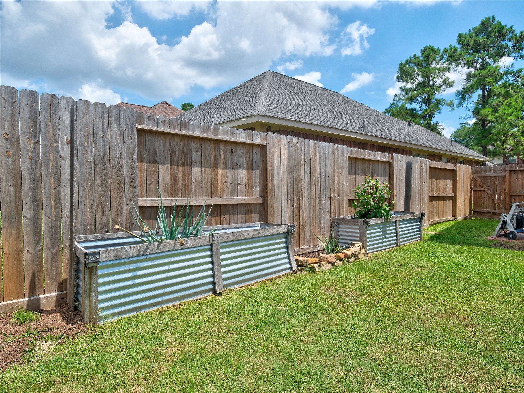 19327 Dickson Park Drive Spring, TX 77373 - Photo 43 of 47 a view of a house with backyard and a garden