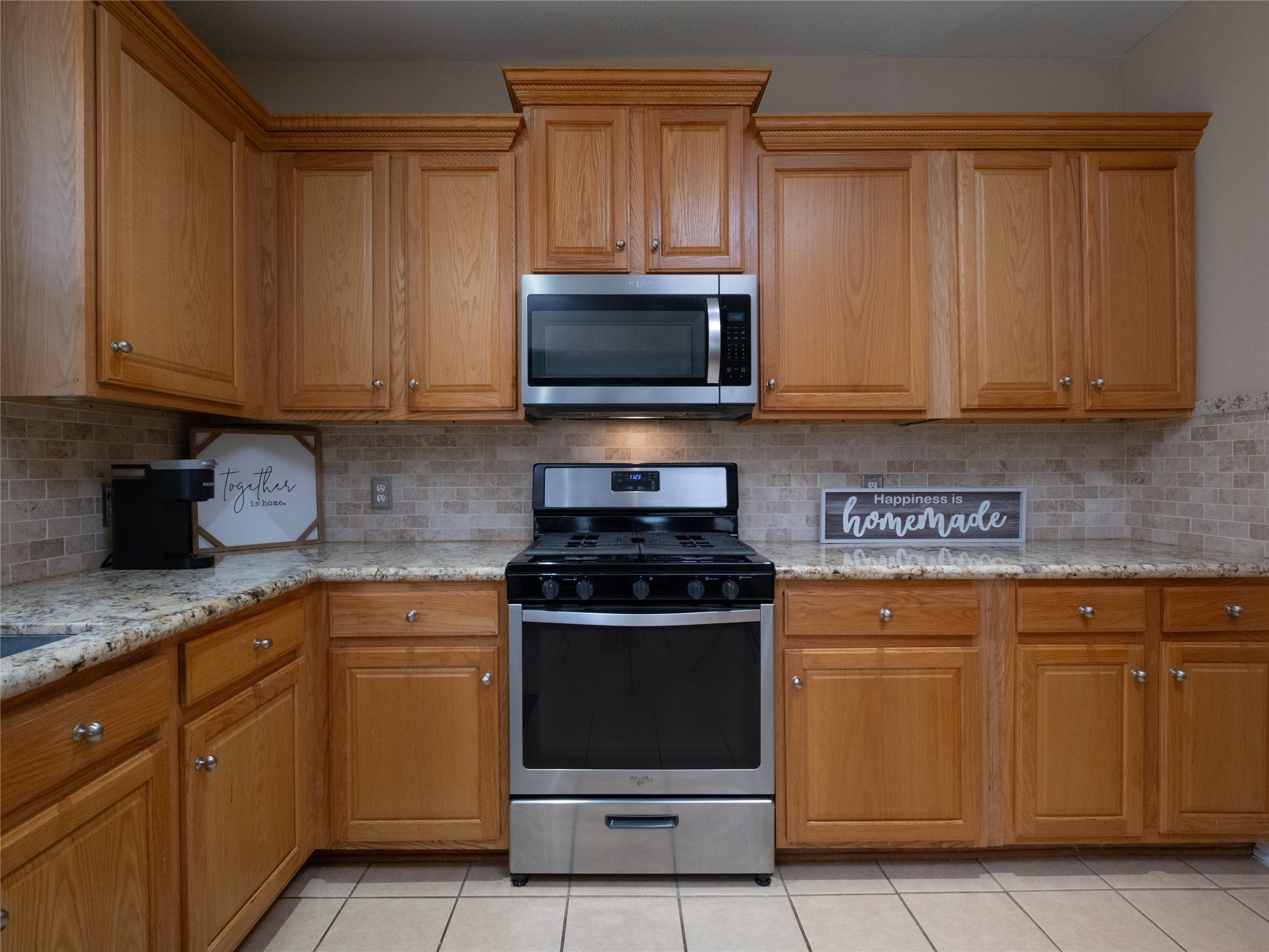 19327 Dickson Park Drive Spring, TX 77373 - Photo 7 of 47 a kitchen with granite countertop wood cabinets and stainless steel appliances