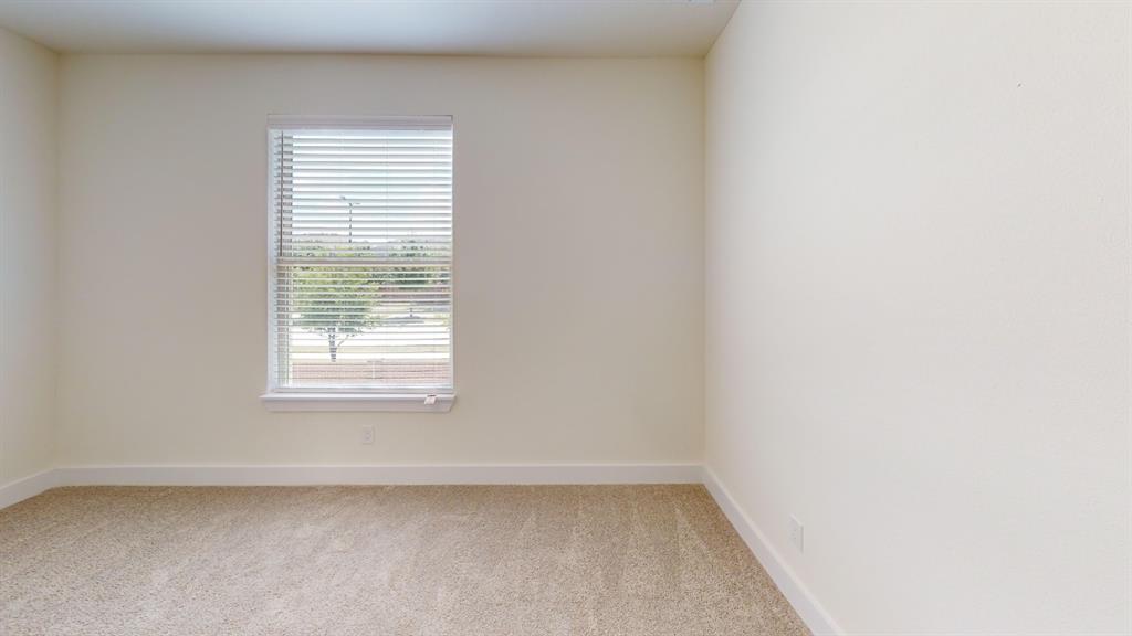 313 Buck Ridge Drive Frisco, TX 75068 - Photo 15 of 20 Neutral-toned room featuring a single window with horizontal blinds, providing natural light