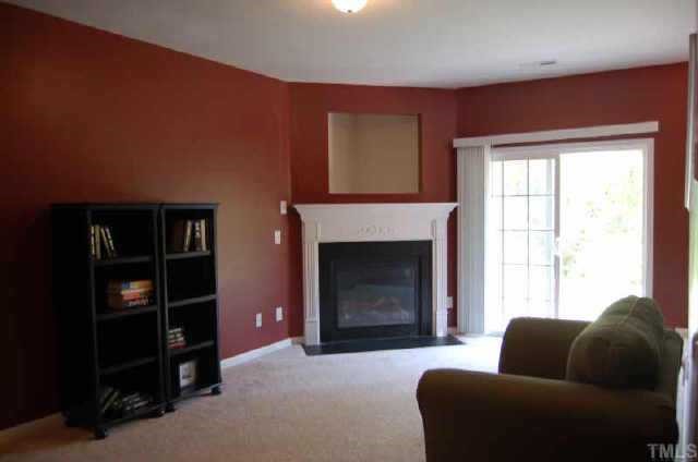 7653 Winners Edge Street Raleigh, NC 27617 - Photo 11 of 12 a living room with furniture and a fireplace