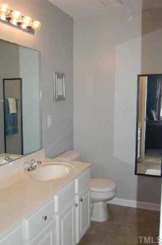 7653 Winners Edge Street Raleigh, NC 27617 - Photo 10 of 12 a bathroom with a sink a toilet and mirror