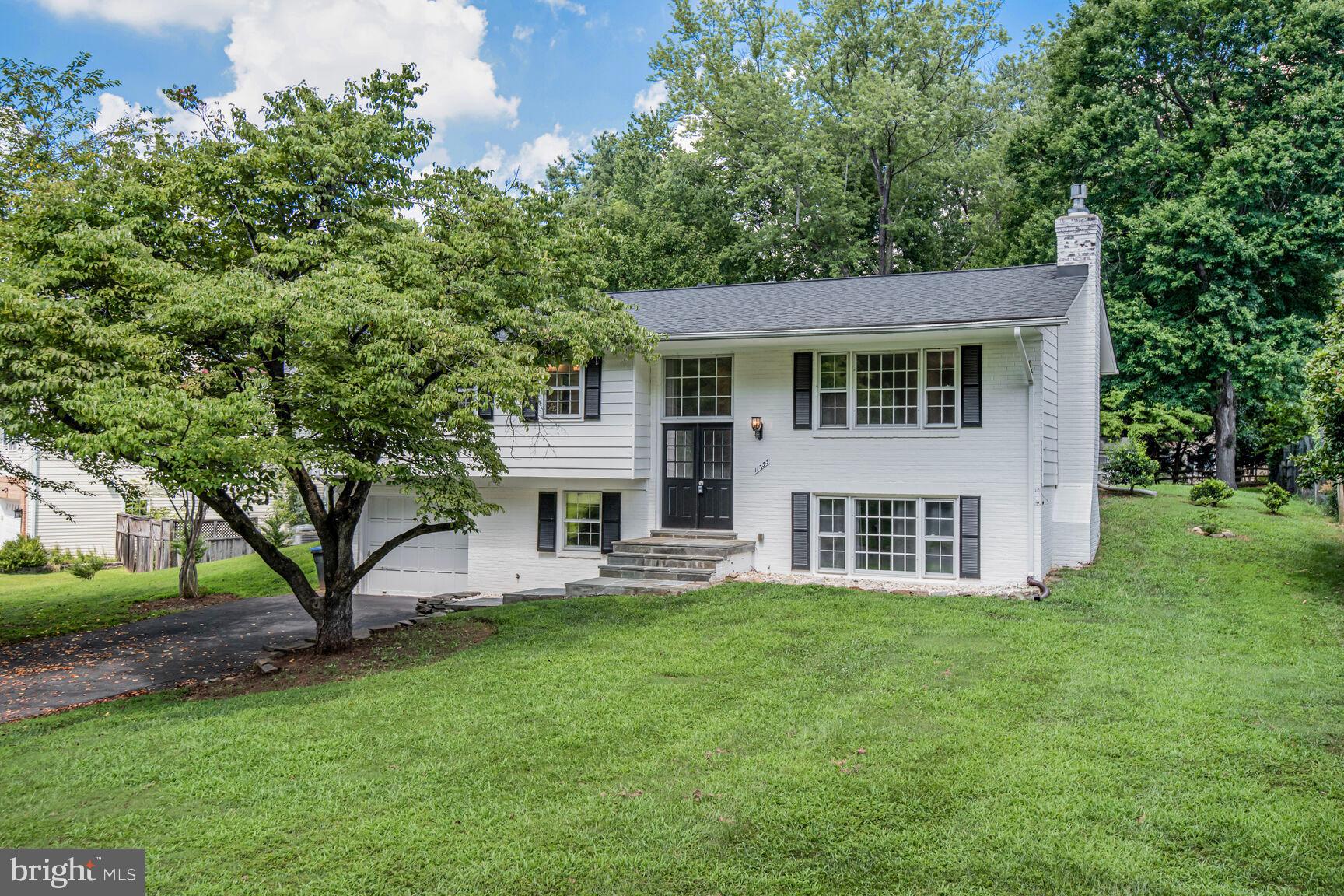 11733 Ambleside Drive Potomac, MD 20854 - Photo 1 of 29 a house view with a sitting space and garden