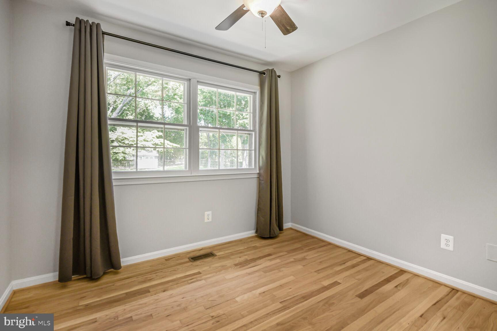 11733 Ambleside Drive Potomac, MD 20854 - Photo 17 of 29 a view of an empty room with wooden floor and a window