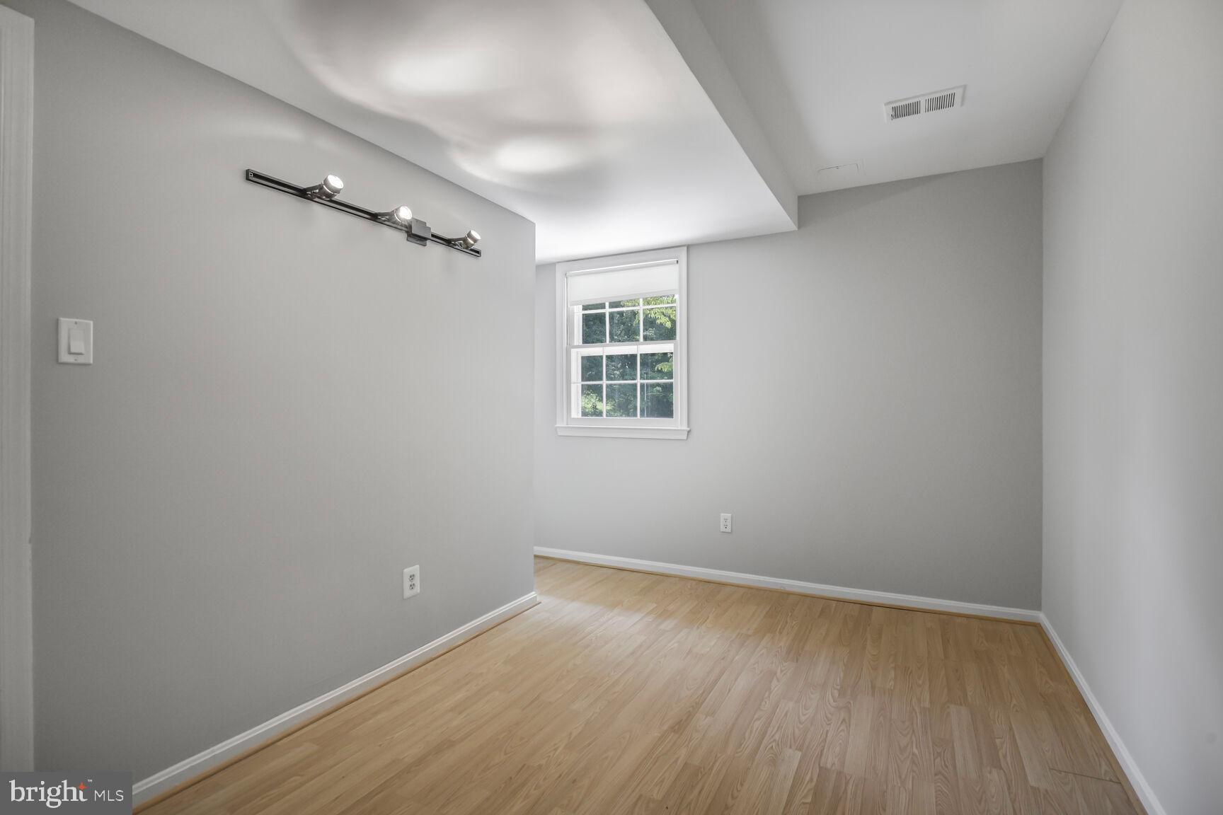 11733 Ambleside Drive Potomac, MD 20854 - Photo 23 of 29 wooden floor in an empty room with a window