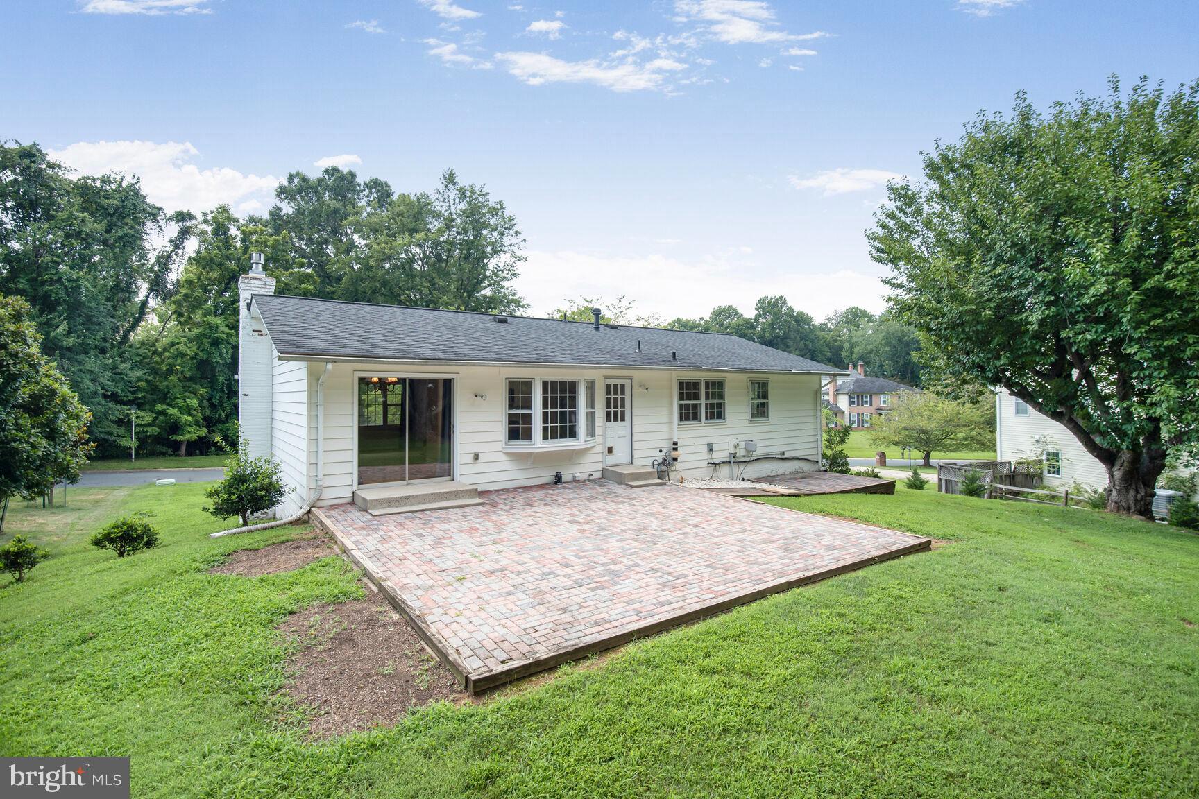 11733 Ambleside Drive Potomac, MD 20854 - Photo 28 of 29 a front view of a house with a garden and patio