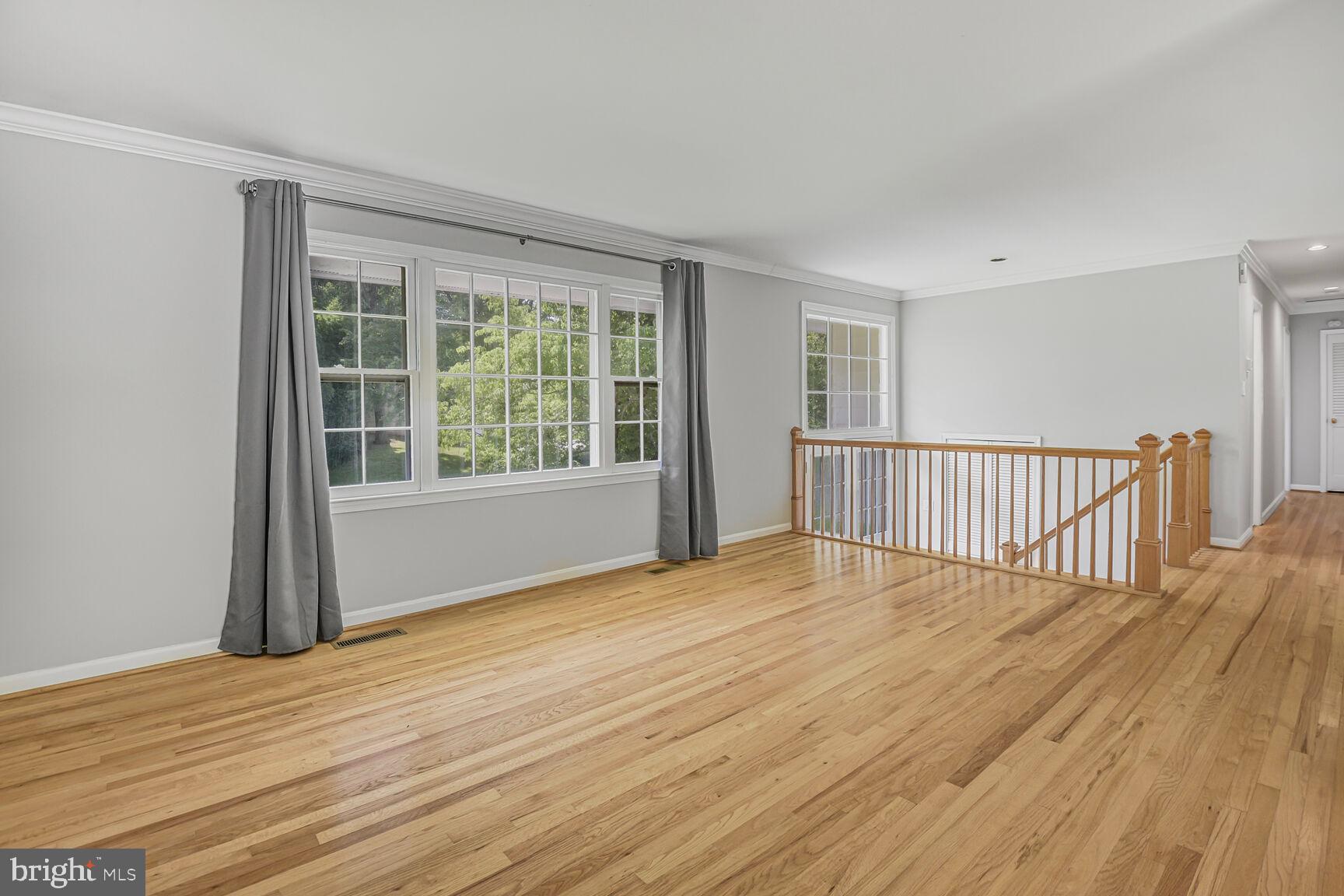 11733 Ambleside Drive Potomac, MD 20854 - Photo 4 of 29 a view of an empty room with wooden floor and a window