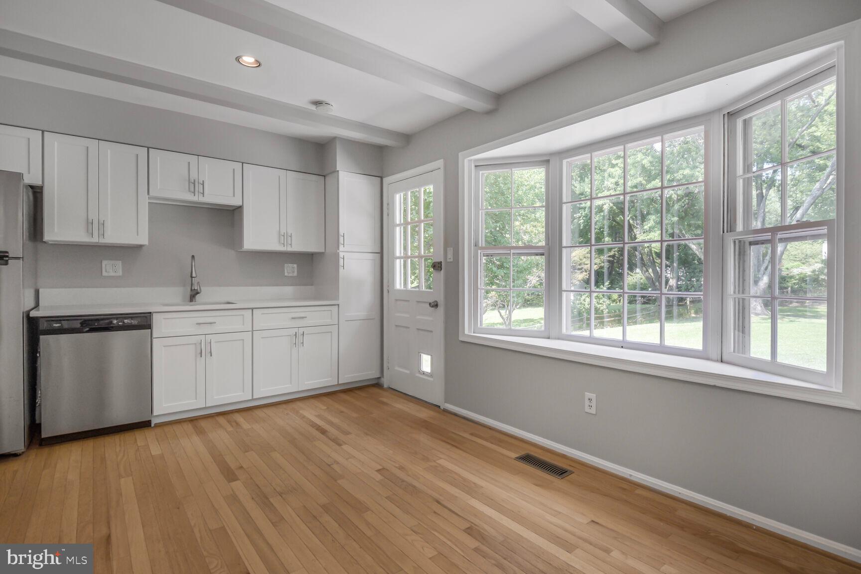 11733 Ambleside Drive Potomac, MD 20854 - Photo 9 of 29 a kitchen with a white cabinets and wooden floor