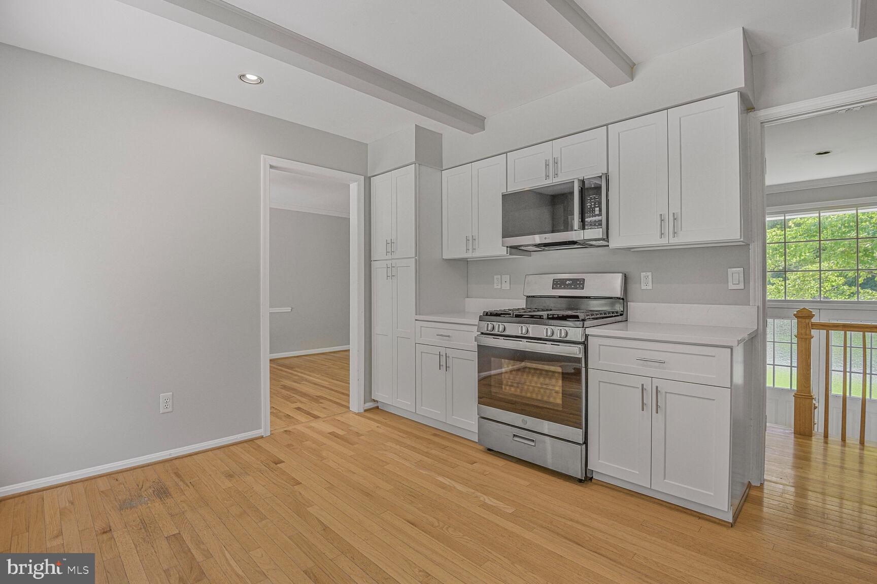 11733 Ambleside Drive Potomac, MD 20854 - Photo 10 of 29 a kitchen with cabinets stainless steel appliances and a window