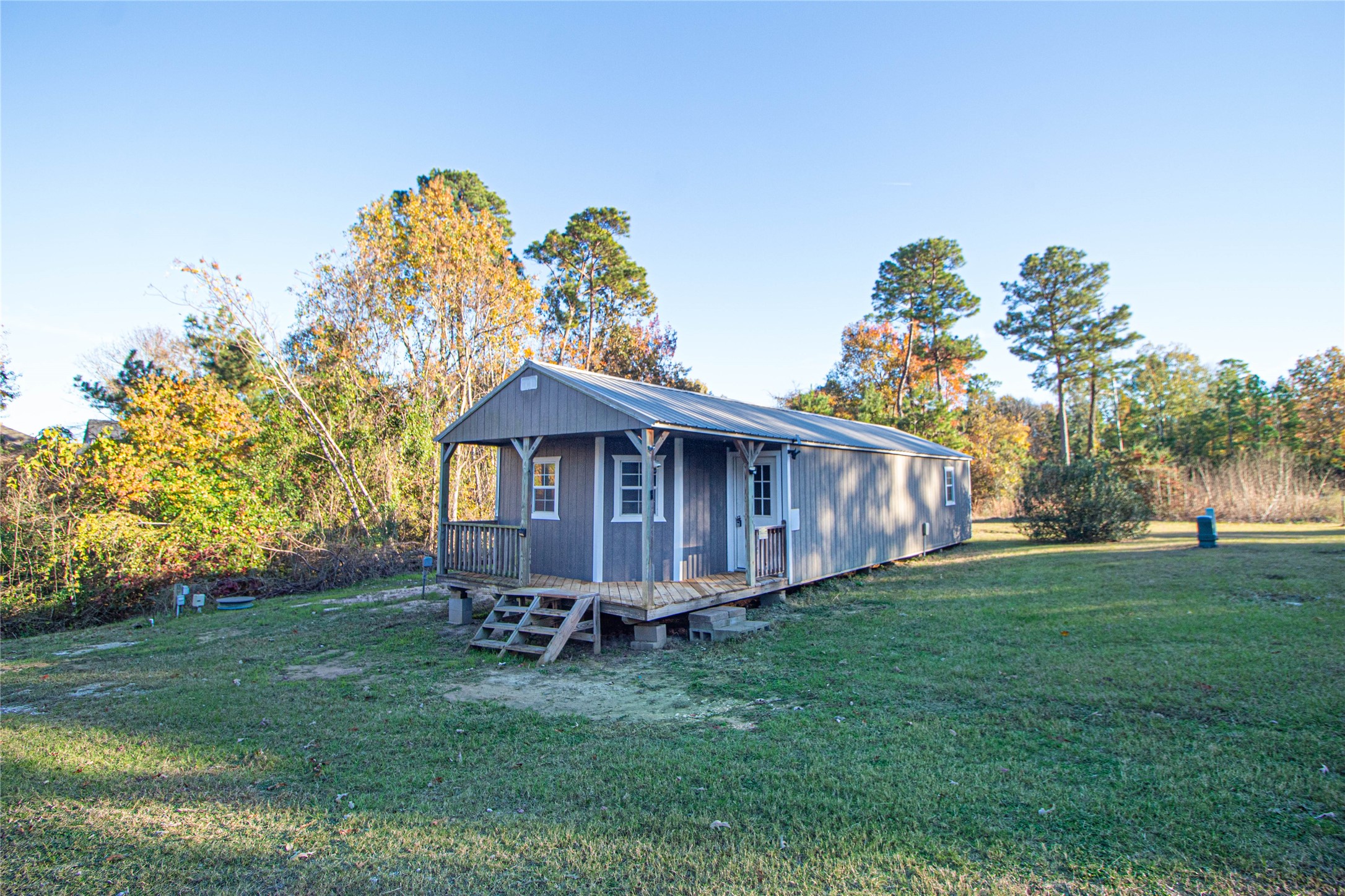 140 Lagoon Drive Point Blank, TX 77364 - Photo 2 of 22 a view of a house with a yard and hanging chair