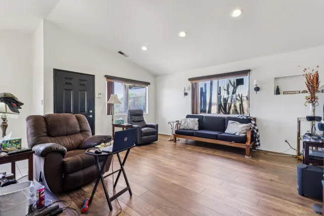 a living room with furniture and wooden floor